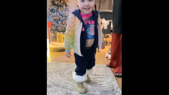 Child walks in Christmas tree boots in Liverpool
