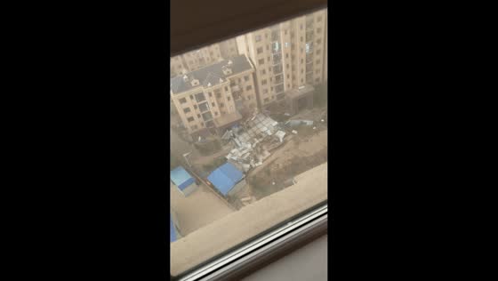 Strong windstorm tears roofing from buildings and damages vehicles in Songyuan, China