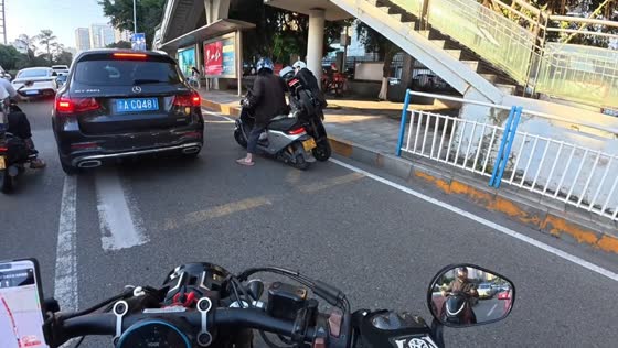 Two e-scooter riders collide while passing through traffic in Chongqing, China