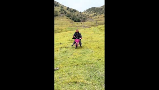 Boy crashes bike downhill after hitting uneven ground in Xizang, China
