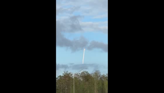 Artemis II rocket launch lights up sky as seen from highway in Orlando, USA
