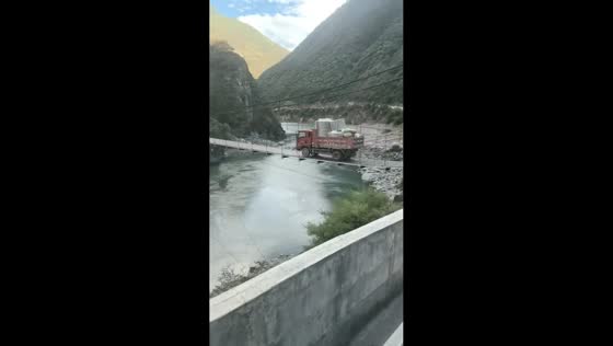 Truck crosses dangerous suspension bridge with heavy load in Sichuan, China