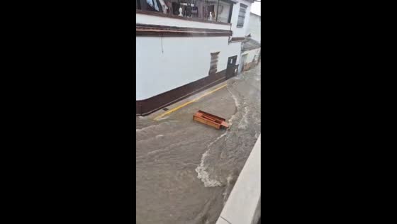 Flooded street sweeps away woodcraft in Bollullos, Spain