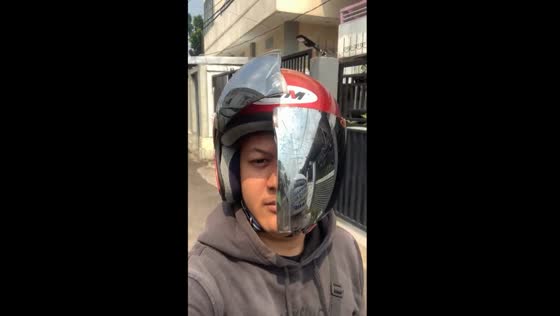 Helmet visor shattered: riding with a broken shield in Pontianak, Indonesia