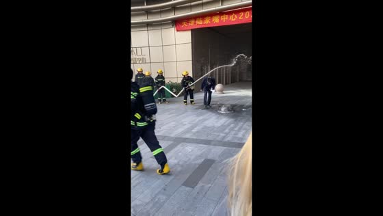 Announcer accidentally soaked during firefighting demo in Tianjin, China