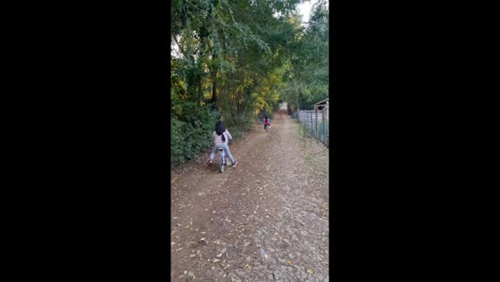 Twin sisters practice bike riding without training wheels in Chillán, Chile