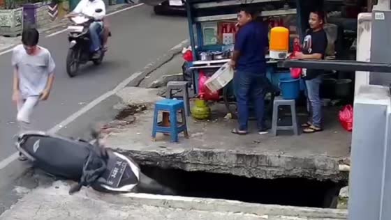 Motorbike falls into water-filled pit in Jakarta, Indonesia