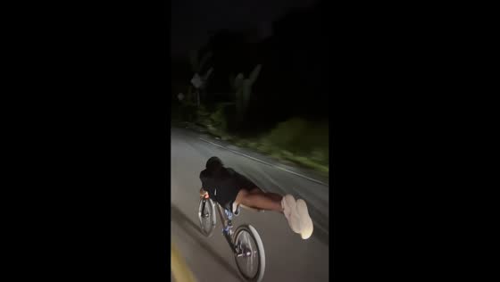 Drag bike riders speed along village road in Takengon, Indonesia