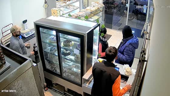 Customer struggles to open push door at cake shop in Mendoza, Argentina