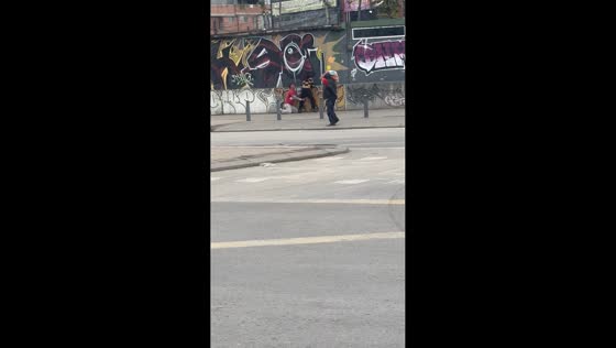 Man clings to woman’s legs in funny street scene in Bogotá, Colombia