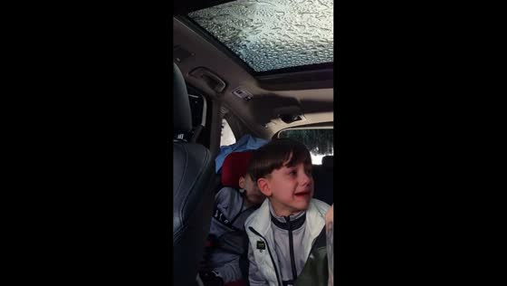 Boy cries during heavy rain in Guidonia, Italy