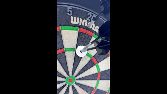 Man achieves Robin Hood-style dart shot through biscuit in Manchester, UK