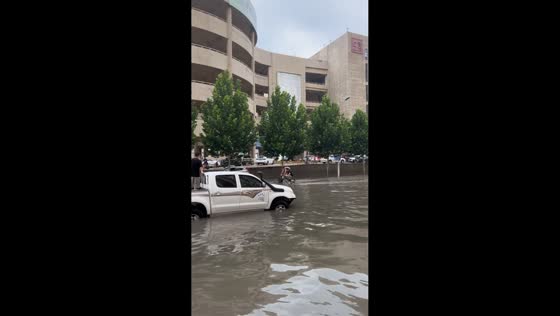 Two riders fall into floodwater after passing car creates wave in Hebei, China