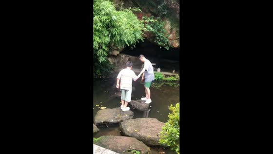 Father and son take back-to-back tumbles into pond in Guangdong, China