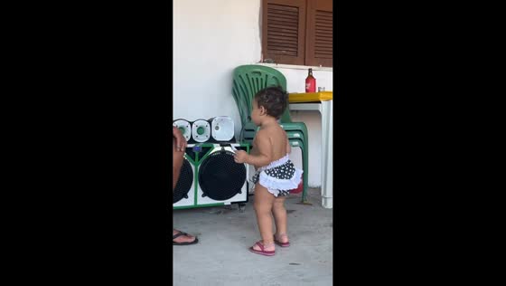 Toddler shows off dance moves in front of speaker in Aracati, Brazil