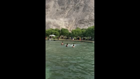 Tourists swim unfazed as landslide unfolds nearby