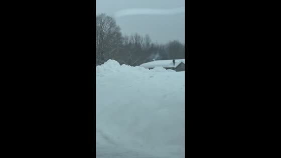 Massive lake-effect snow buries homes with towering roof drifts in New York, USA