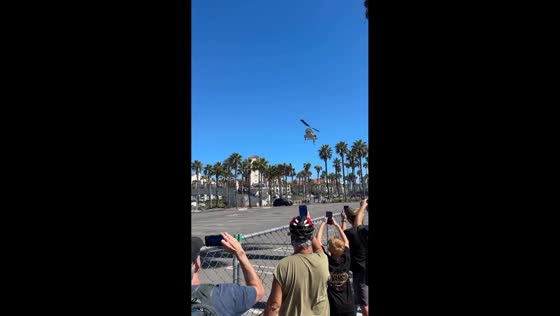 Helicopter crashes near beachside palm trees, Huntington beach, California, USA
