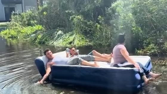 Air bed rowing in Tampa flood after Hurricane Milton