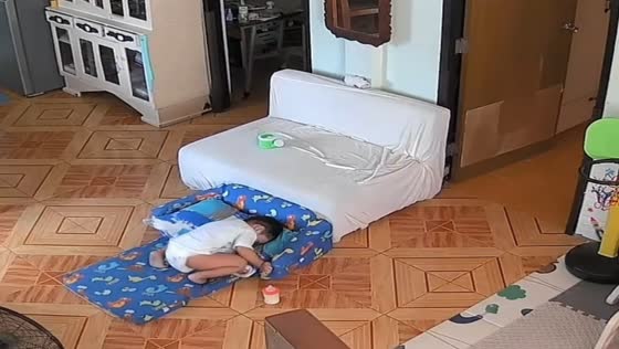 Toddler sets up resting spot after cleaning in Naga, Philippines