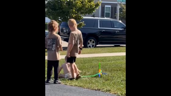 Three brothers enjoy playful launch on toy pump in USA