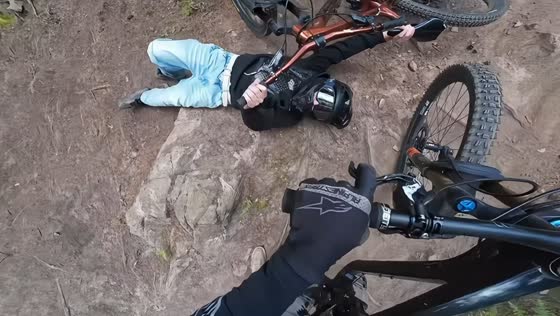 Teen biker trips while walking backward at Isaberg Bikepark in Hestra, Sweden
