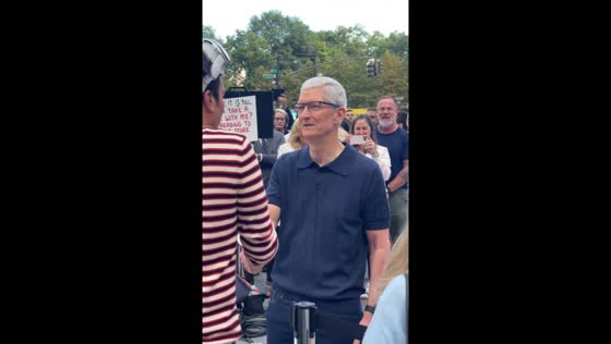 Tim Cook greets customer waiting in line at Apple Fifth Avenue, New York, USA