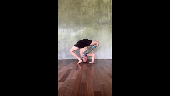 Man demonstrates extreme flexibility during yoga in Ubud, Bali, Indonesia