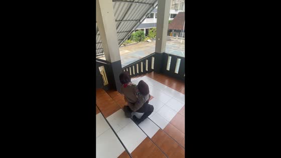 Two friends trip and fall on stairs in Malang, Indonesia