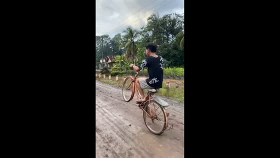 Failed wheelie attempt on bicycle in Palembang, Indonesia