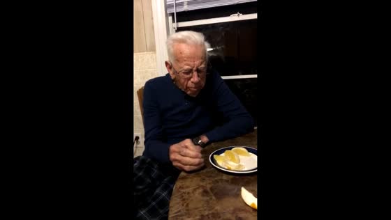 Grandfather bites into sour lemon thinking it’s an orange in Paradis, Louisiana, USA
