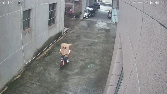 Boy rides bicycle wearing cardboard box in Fujian, China