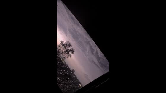 Lightning illuminates stormy sky during rainy drive in Havre, USA
