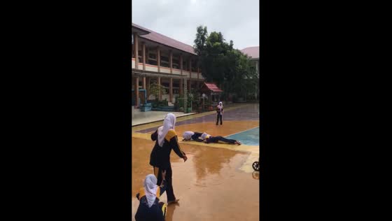 Wet field chronicles: laughter amidst drizzle as friends take a tumble