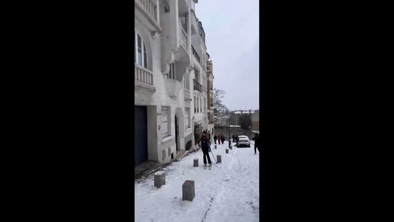 Woman skis through Montmartre streets amid rare snowfall in Paris, France