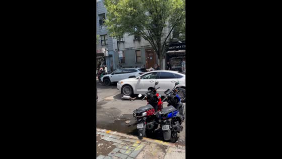 Car rips off muffler after hitting raised sewer in Brooklyn, New York