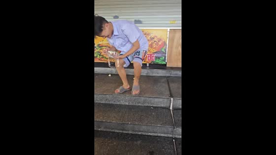 Man slips with cake on stairs in Guangdong, China