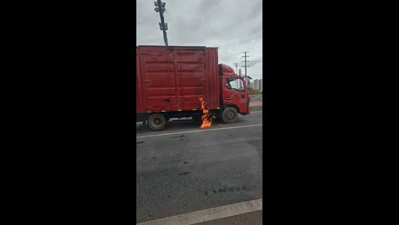 Truck fire erupts beneath cargo area on roadside in Guangxi, China