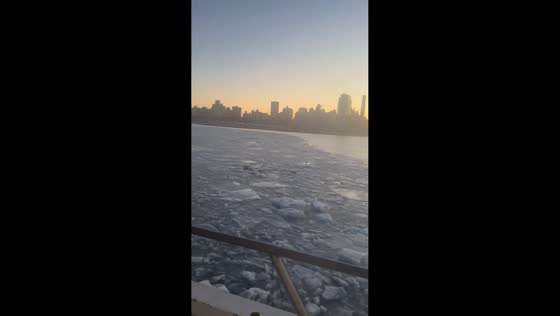 Ice floes drift across water near Port Liberty Ferry Stop in New Jersey, USA