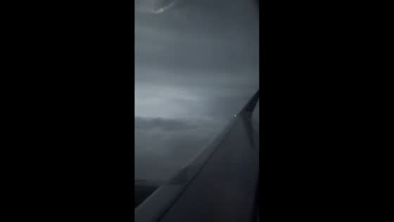 Airliner flies through lightning-filled thunderstorm over Barcelona, Spain