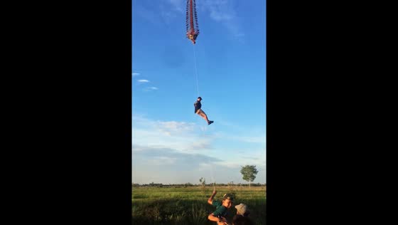 People ride dragon kites in Lampung, Indonesia