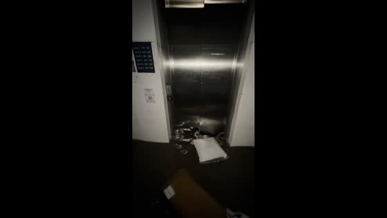 Residents struggle to escape flooded building in Stockport, England, UK
