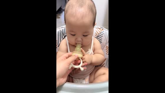 Baby tries fruit feeder for the first time in Liaoning, China