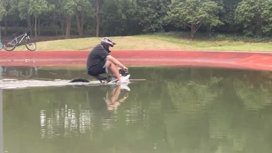 Bicyclist navigates deep water pool in Jiangsu, China