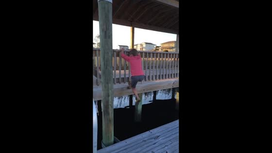 Boy falls into water during jump attempt on dock in Holden Beach, North Carolina, USA