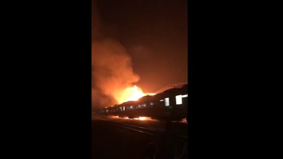Train passes through large fire near tracks in West Java