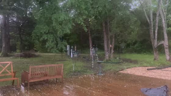 Hail slowly covers wooden deck during storm in Elkins, Arkansas, USA