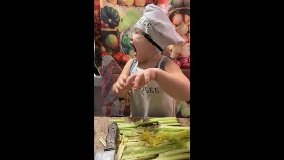 Child's 'behind the scenes' silliness with plastic knife