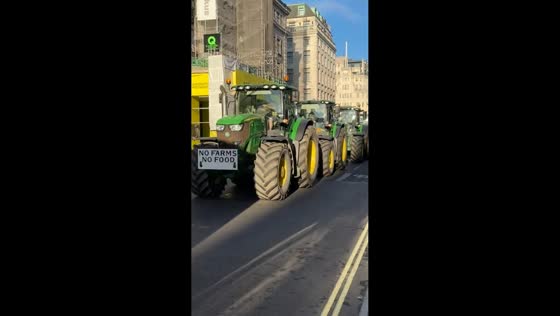 Farmers convoy of tractors moves through central London in England, UK