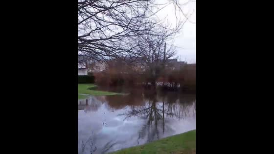 River Bovey overflows during Storm Chandra in Bovey Tracey, Devon, UK